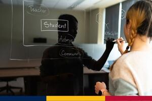 image of graduate student writing on a glass whiteboard