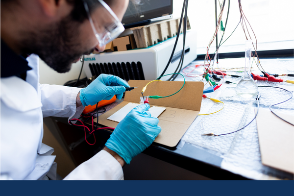 Chemistry student examines wiring in an experiment