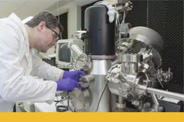 Faculty member performs surface analysis experiment