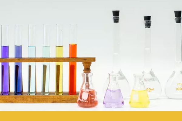 Different sets of vials and flasks with coloured liquid inside them