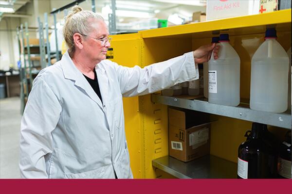 Staff member wearing a lab coat working at the Department of Chemistry