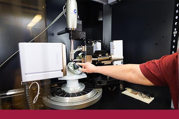 Staff member works with lab equipment at Chernoff Hall