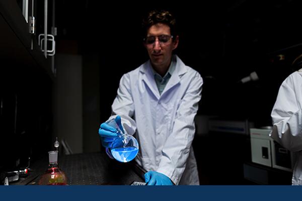 Chemistry student performs lab work in a lab at Chernoff Hall