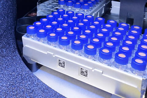 Photo: Autosampler Vial Tray. High-angle view of an automated tray holding rows of glass sample vials.