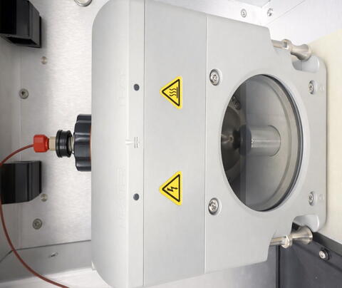 Photo: ESI Source Chamber. Close-up view of the metallic ionization source housing on a mass spectrometer.