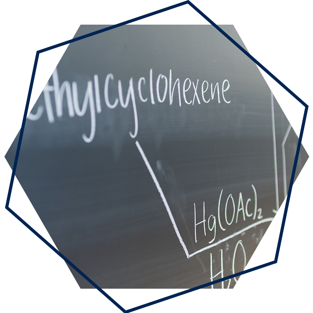 Chalkboard closeup with the word "methylcyclohexene" written with a chemical equation