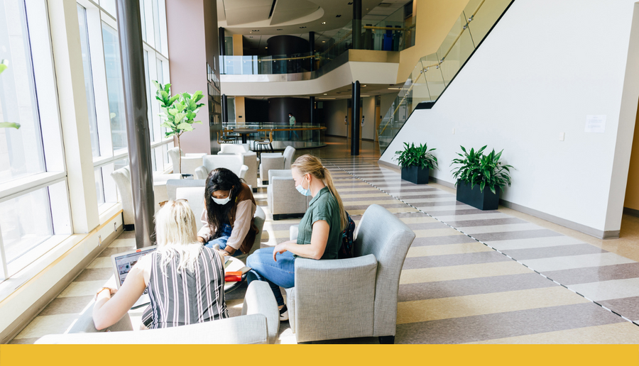 students sitting discussing chemistry in the 4th floor gathering space in Chernoff Hall at Queen's University