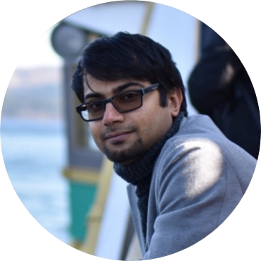 A person wearing glasses and a grey coat

AI-generated content may be incorrect.